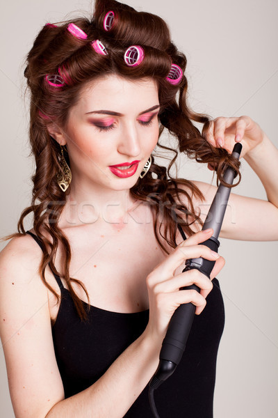 the girl with the curling Tong curler makes hairstyle Stock photo © dmitriisimakov