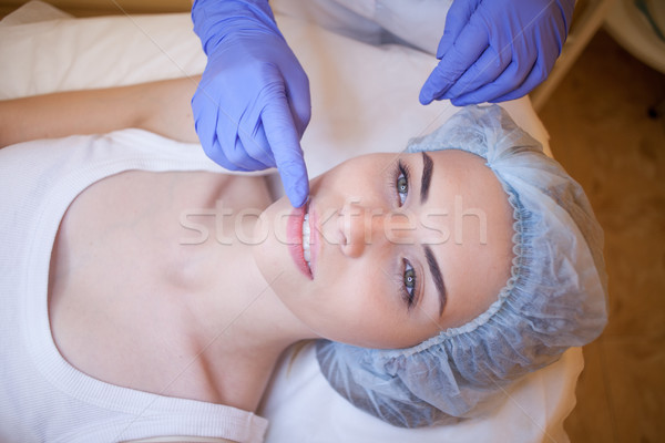 Cosmetology doctor makes woman treatments facial massage Stock photo © dmitriisimakov