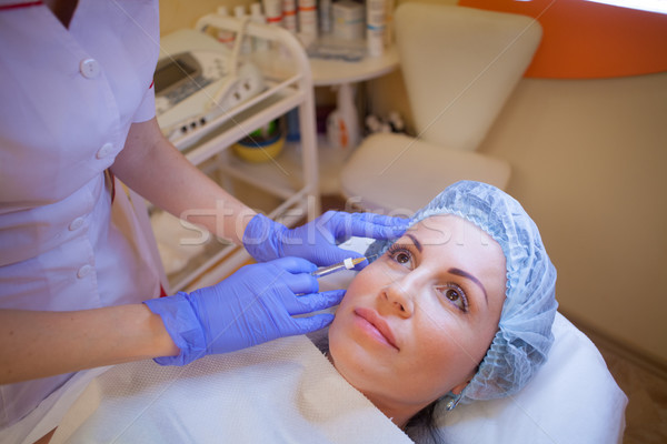 doctor beautician increases lip patient an injection syringe Stock photo © dmitriisimakov
