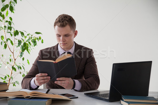 a man in a business suit works at the computer with books in the Office Stock photo © dmitriisimakov