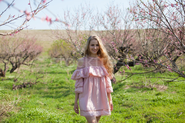 blonde girl walks the garden blossoming peach Stock photo © dmitriisimakov