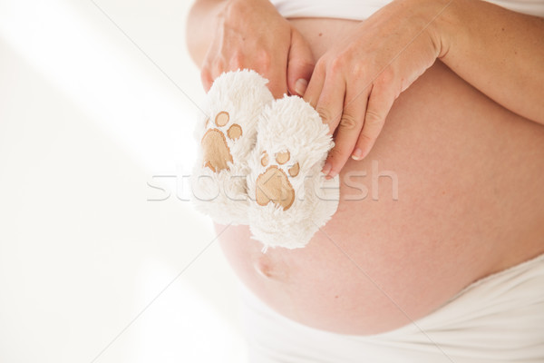 the stomach of a pregnant woman and baby stuff socks 1 Stock photo © dmitriisimakov