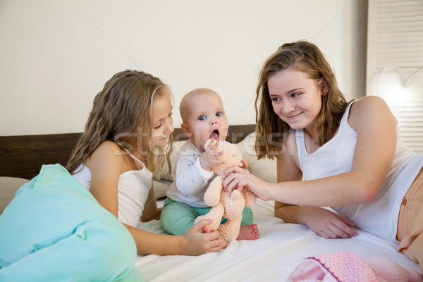 three sisters baby girl children in the morning on the bed in the bedroom Stock photo © dmitriisimakov