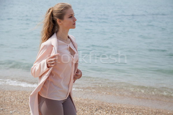 blonde girl walks along the beach of the sea coast Stock photo © dmitriisimakov