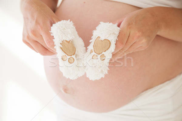 the stomach of a pregnant woman and baby stuff socks 1 Stock photo © dmitriisimakov