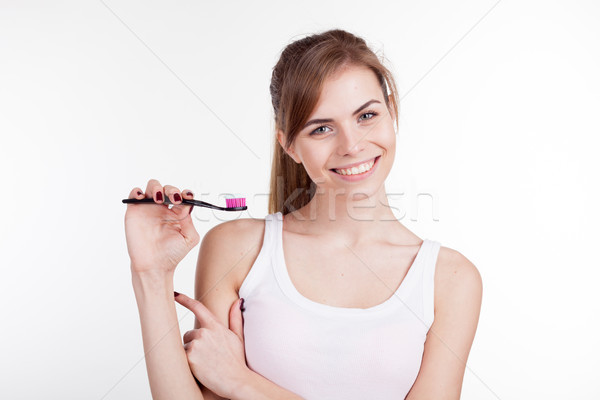 girl shows the finger on the toothbrush smile teeth Stock photo © dmitriisimakov