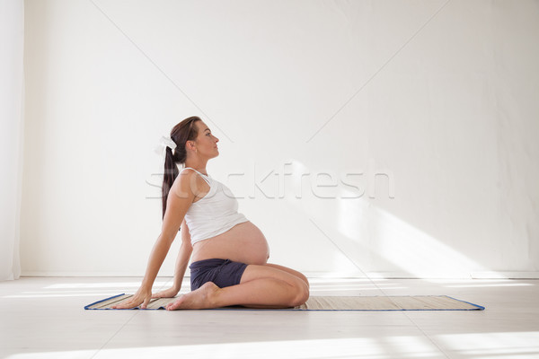 a pregnant woman is engaged in gymnastics and yoga Stock photo © dmitriisimakov