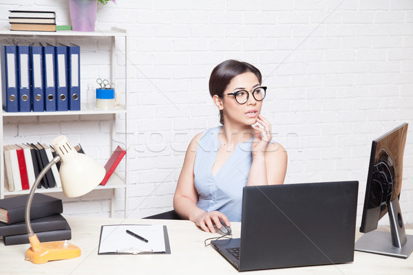 business girl sits in an Office behind a desk with a computer Stock photo © dmitriisimakov