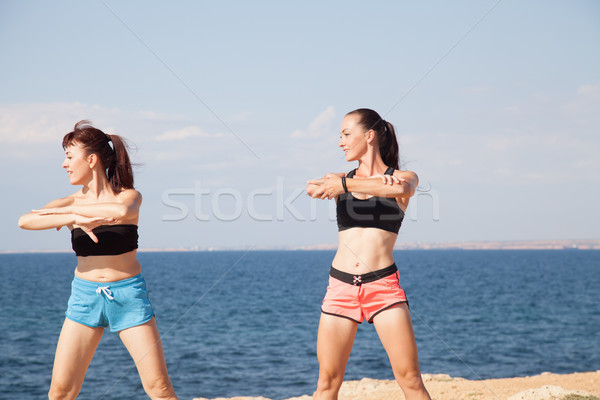 two girls play sports fitness on the beach Stock photo © dmitriisimakov