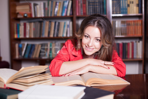 girl is preparing for the exam in the library reads books Stock photo © dmitriisimakov