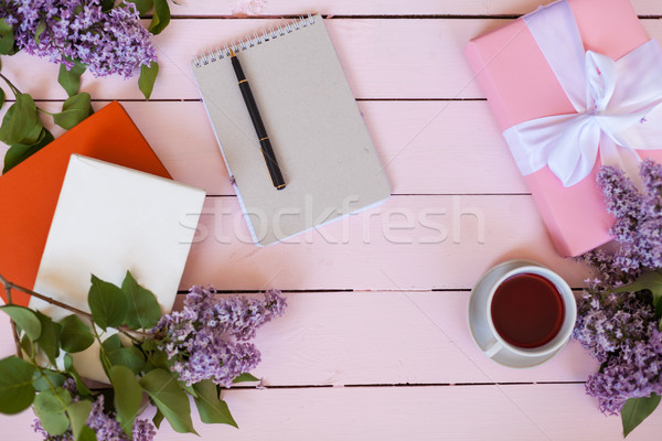 on the white table lilac, gift, notebook, cup of tea Stock photo © dmitriisimakov