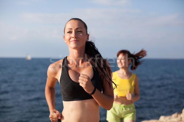 girls play sports running around on the Beach Stock photo © dmitriisimakov