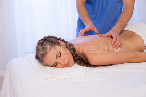 a woman doing a back massage in the Spa 1 Stock photo © dmitriisimakov