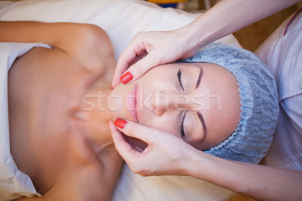 Cosmetology doctor makes woman treatments facial massage Stock photo © dmitriisimakov