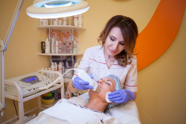 Cosmetology doctor makes the procedure a woman face cleaning Stock photo © dmitriisimakov