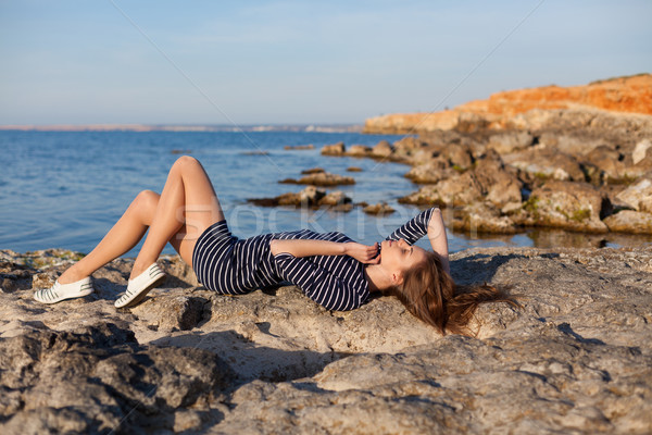 girl lies on her back on a stone Beach Stock photo © dmitriisimakov