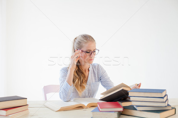 female teacher sitting at a table of many books Office Stock photo © dmitriisimakov