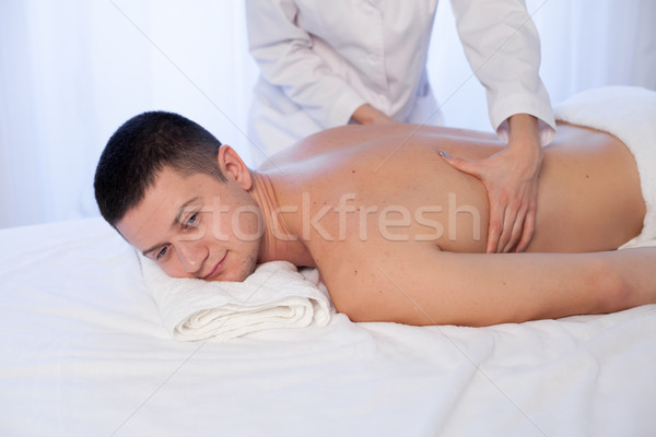 a massage therapist makes therapeutic massage man Spa Stock photo © dmitriisimakov