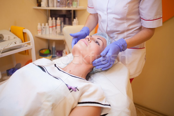 doctor cosmetologist doing facial massage girl spa Stock photo © dmitriisimakov