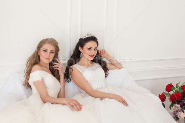Portrait of two young women in wedding dresses in White Hall Stock photo © dmitriisimakov