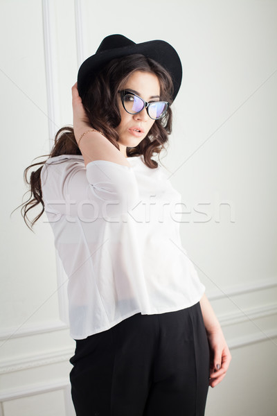 beautiful girl with Hat and glasses in the Studio curls hairstyle Stock photo © dmitriisimakov