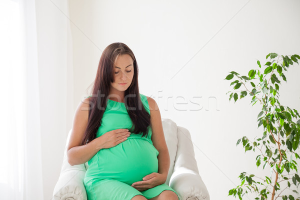 Terhes nő szülés fehér kanapé nő boldog Stock fotó © dmitriisimakov