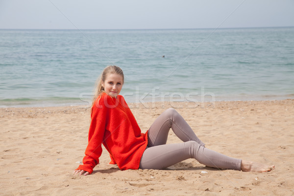 the blonde in the red walks along the beach of the sea coast Stock photo © dmitriisimakov