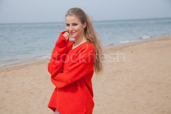the blonde in the red walks along the beach of the sea coast Stock photo © dmitriisimakov