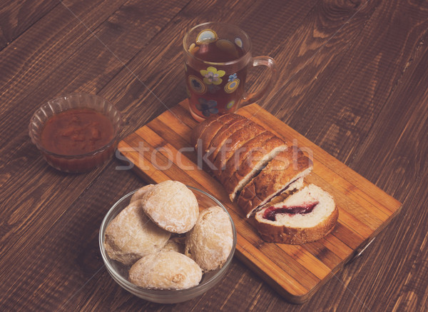Cutted loaf with tea, jam and buns Stock photo © dmitroza