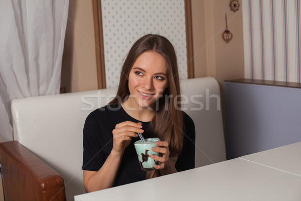 Stock photo: Young woman drinking coffee