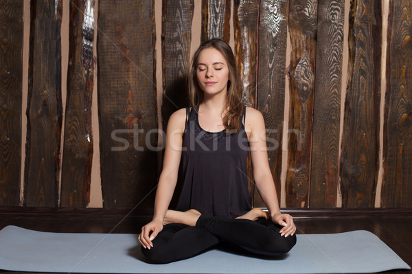 Woman is doing yoga exercises Stock photo © dmitroza
