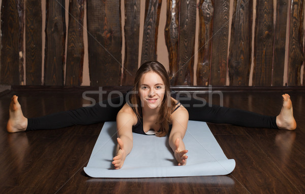 Woman is in Wide-angle seated Forward bend pose Stock photo © dmitroza