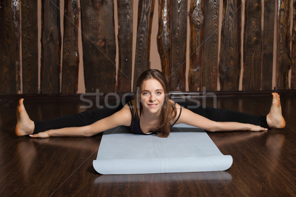 Woman is in Wide-angle seated Forward bend pose Stock photo © dmitroza