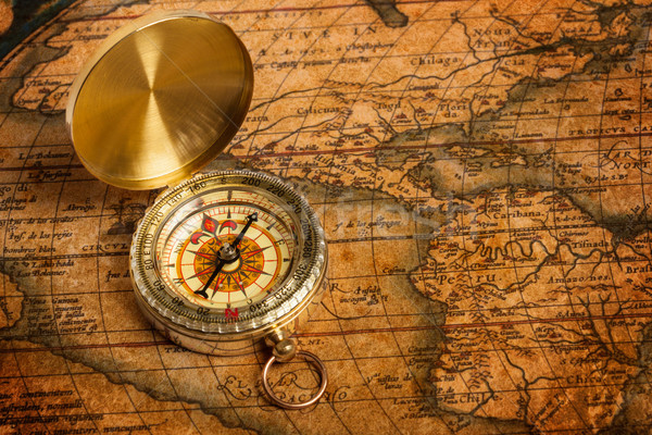 Old vintage golden compass on ancient map Stock photo © dmitry_rukhlenko