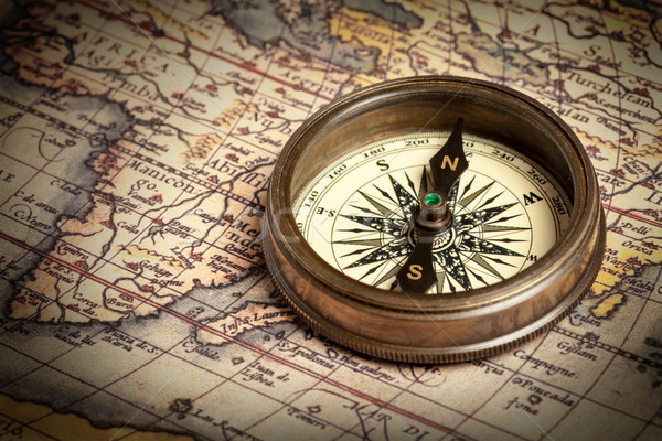 Stock photo: Old vintage compass on ancient map