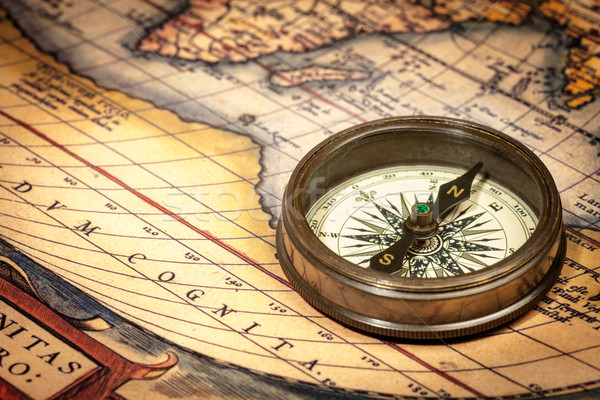 Old vintage compass on ancient map Stock photo © dmitry_rukhlenko