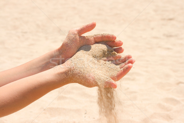 Stock photo: Sand running through hands