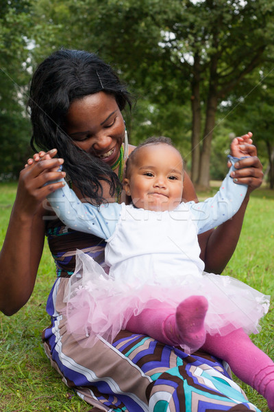 Stock photo: Mother is playing with her girl