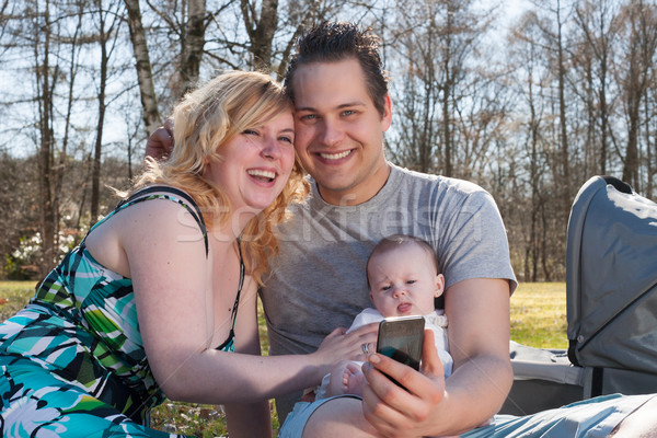 Young family is taking a picture with the smartphone Stock photo © DNF-Style