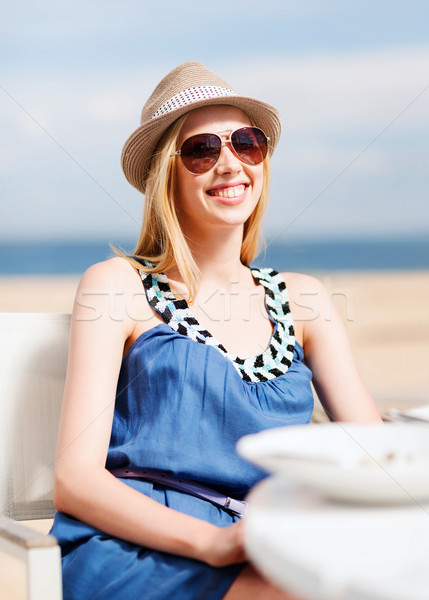girl in shades in cafe on the beach Stock photo © dolgachov