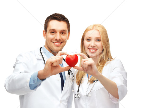 doctors cardiologists with heart Stock photo © dolgachov