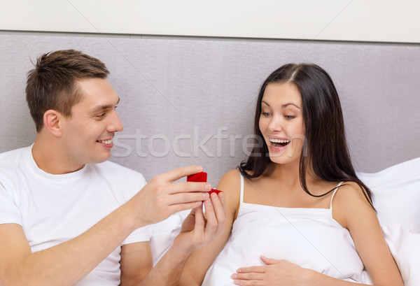 man giving woman little red box and ring in it Stock photo © dolgachov