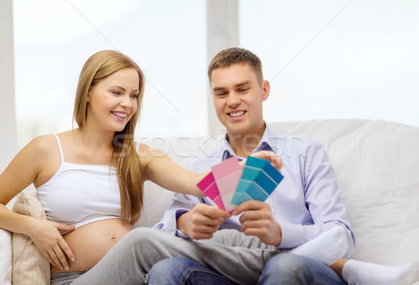 expecting parents choosing color for nursery Stock photo © dolgachov