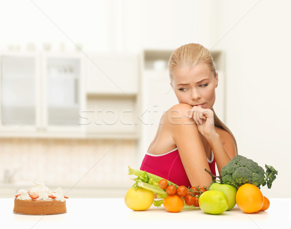doubting woman with fruits and pie Stock photo © dolgachov