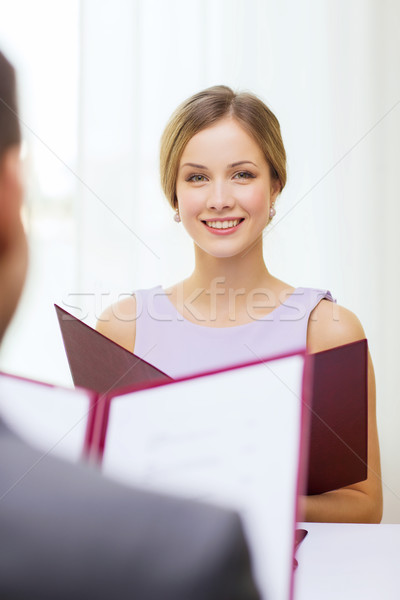 smiling young woman with menu at restaurant Stock photo © dolgachov