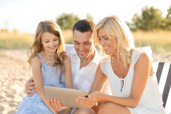 smiling family at beach with tablet pc computer Stock photo © dolgachov