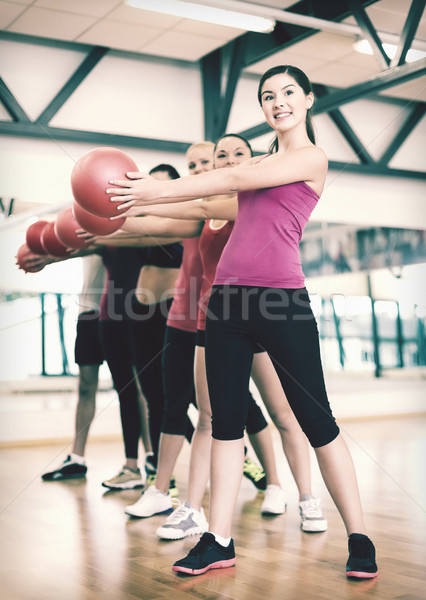 Stock photo: group of smiling people working out with ball