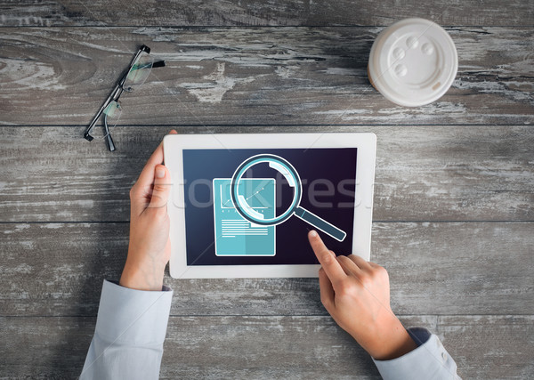 Stock photo: close up of hands with tablet pc and statistics