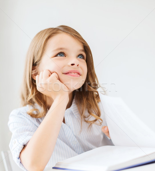 Stock photo: student girl writing in notebook at school