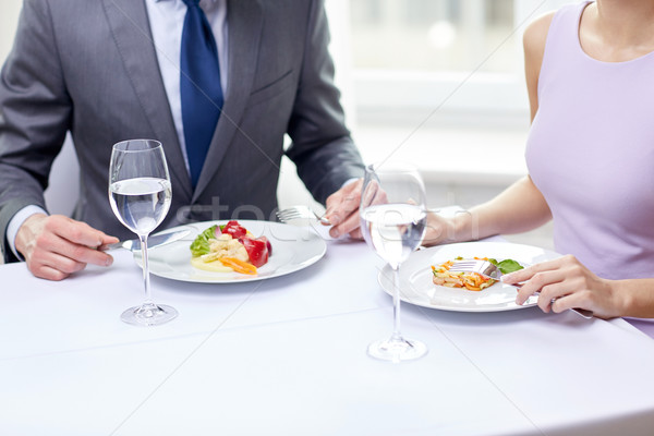 close up of couple eating appetizers at restaurant Stock photo © dolgachov